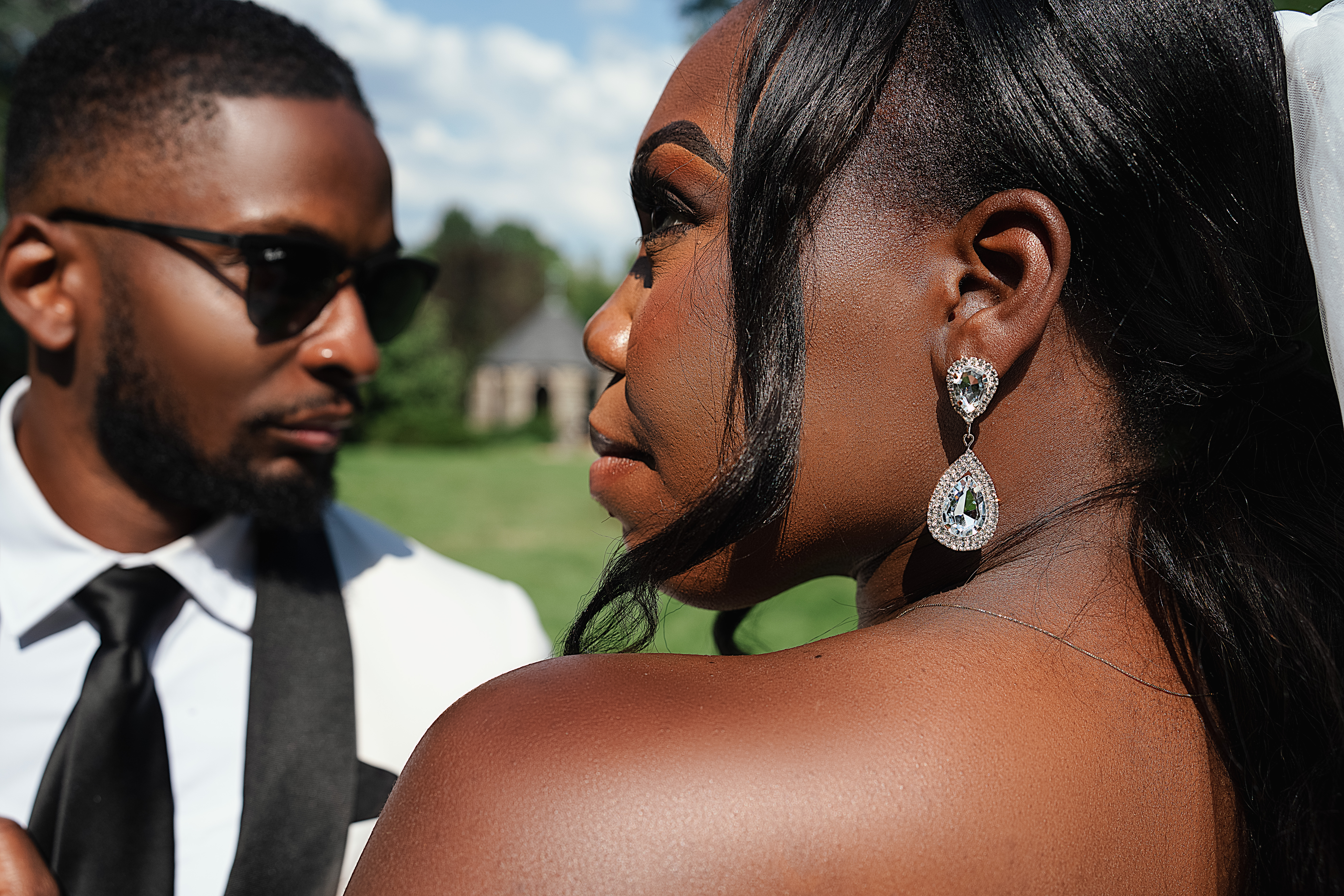 Black bride wearing diamond earrings from Tiffany Co. at Washington DC’s National cathedral