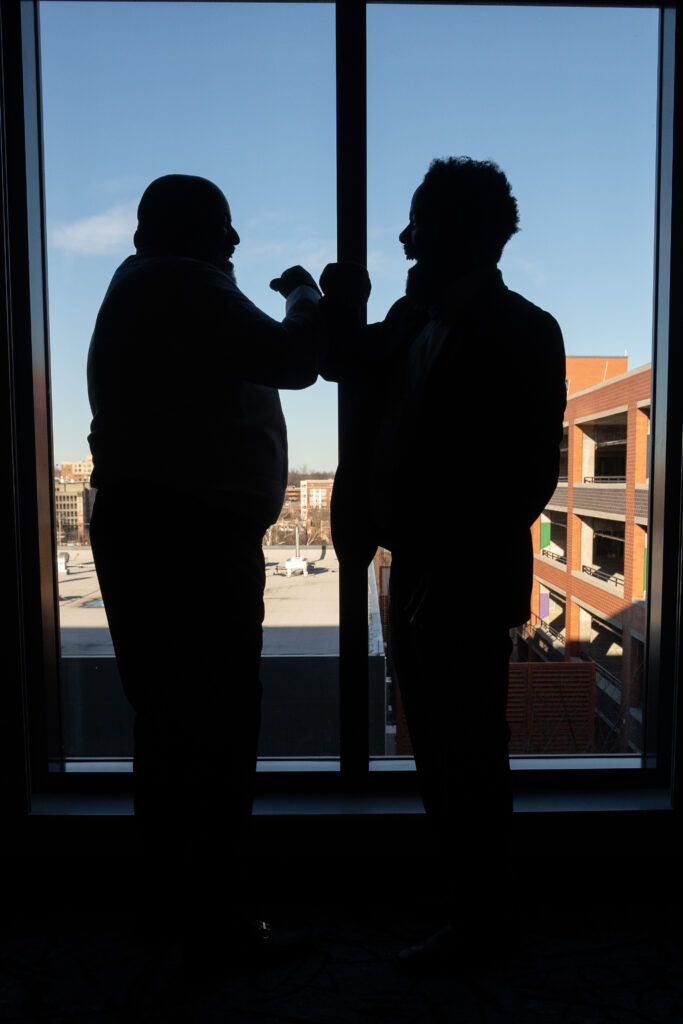 The groom and best man sharing important moments before the wedding at the Hotel at the University of Maryland wedding venue.