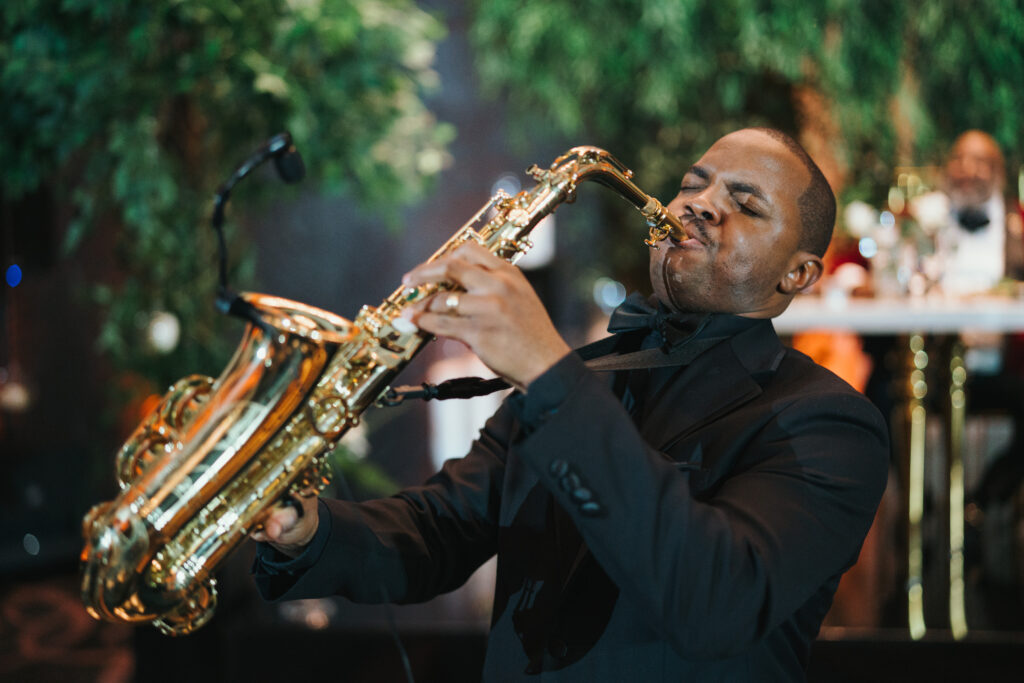 DMV saxophonist, Tony C serenading wedding guest at the Hotel at the University of Maryland wedding 
