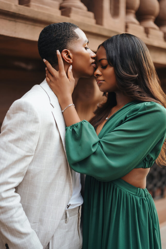 black man kissing black women in baltimore in green dress