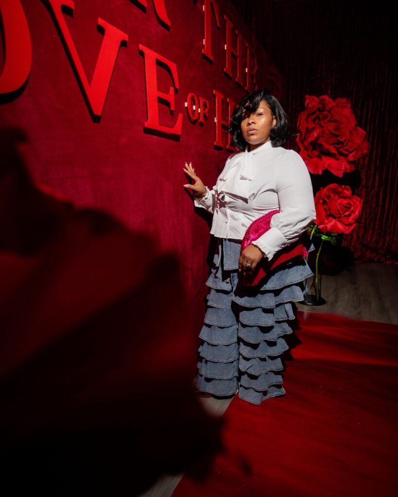 owner of party whisperers posing by wall